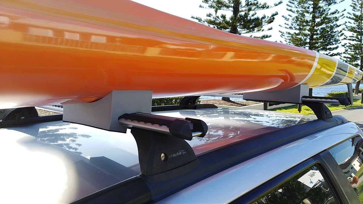 SLSC racing ski supported by foam kayak mounts on car roof rack