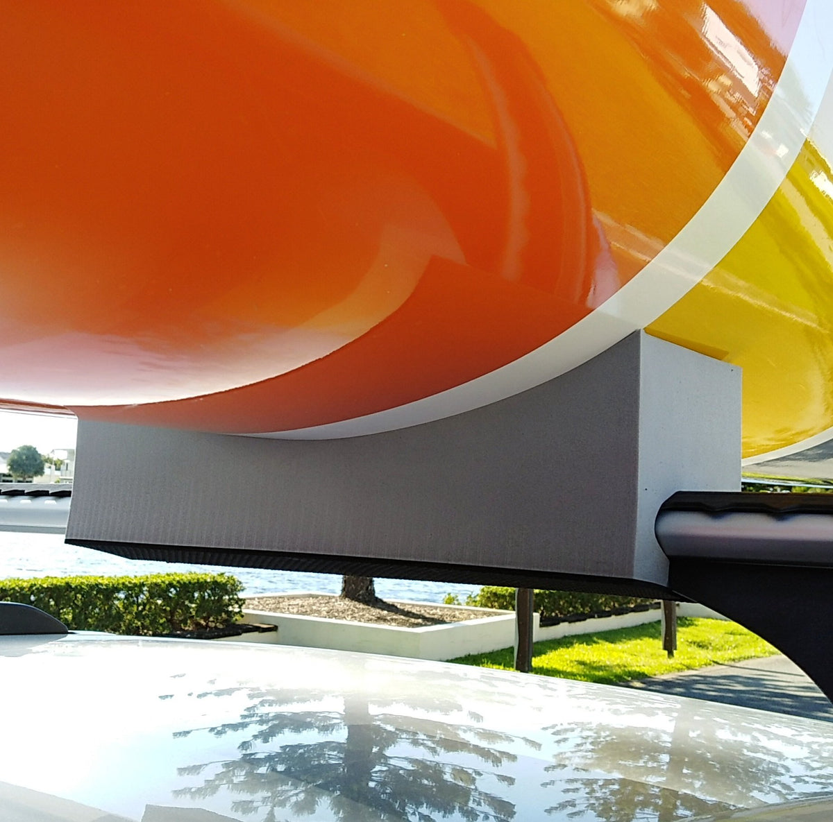 close up of SLSC racing ski supported by foam kayak mounts on car roof rack